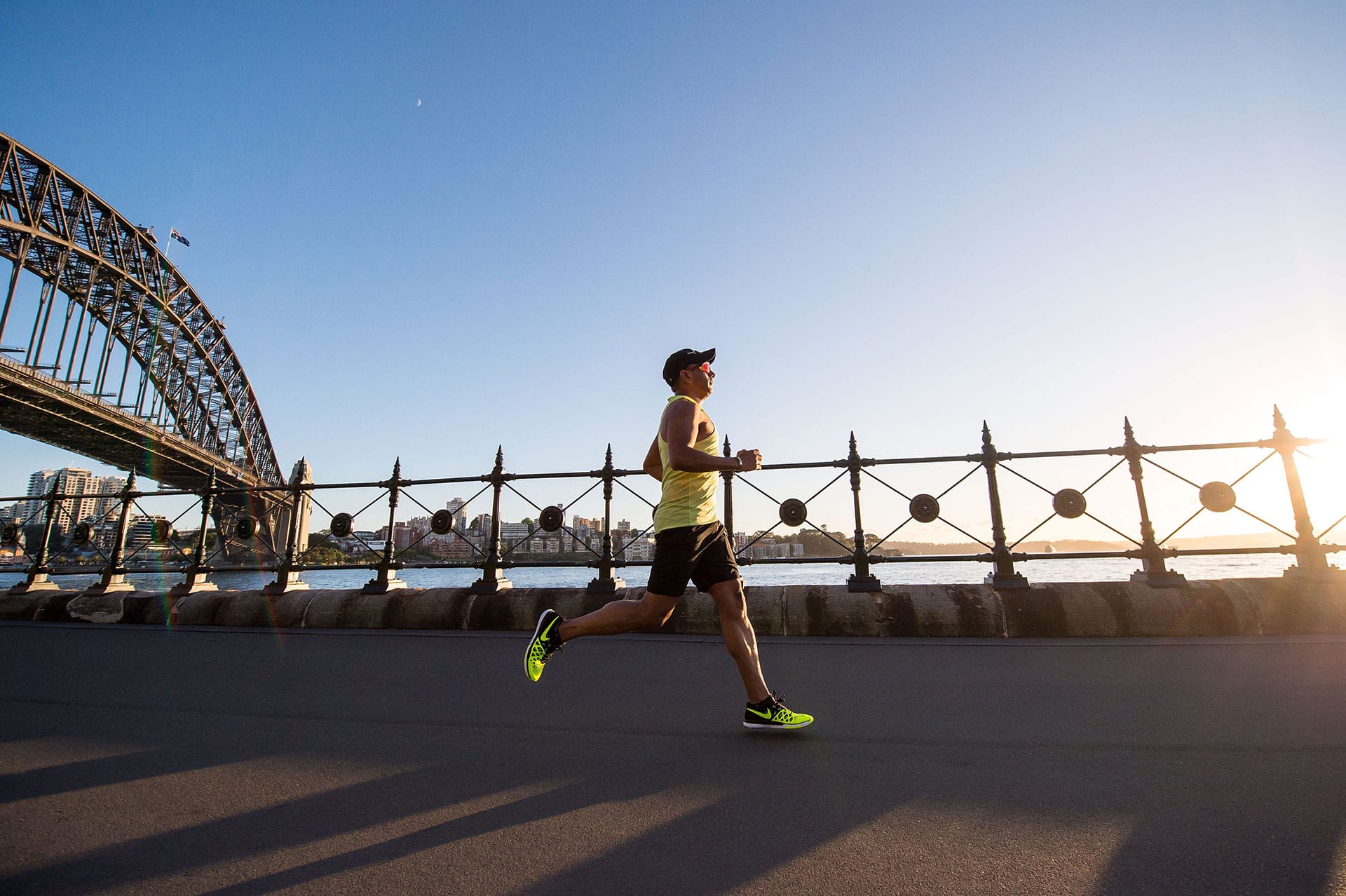 A man triumphantly jogs by a bridge, overcoming initial reluctance