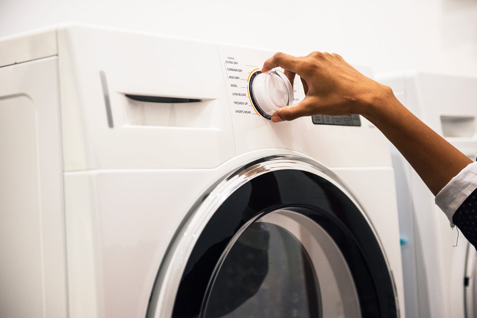 Woman using epsom salt to clean her washing machine