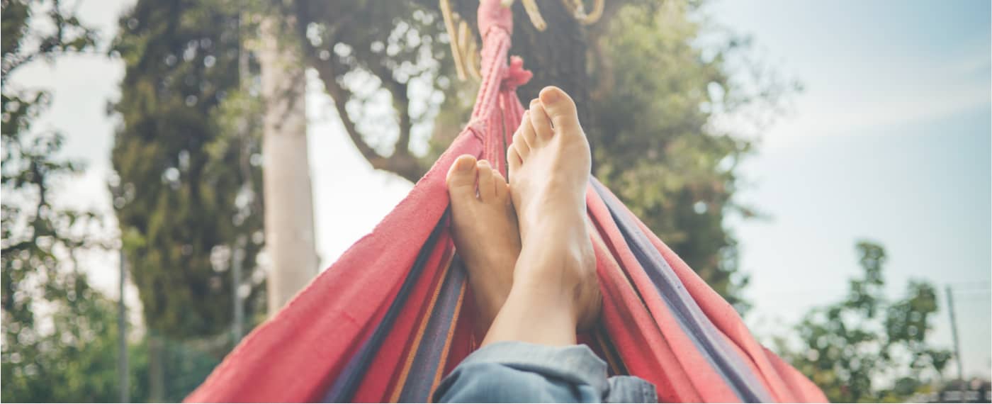 A person taking a mental day to lounge in a hammock