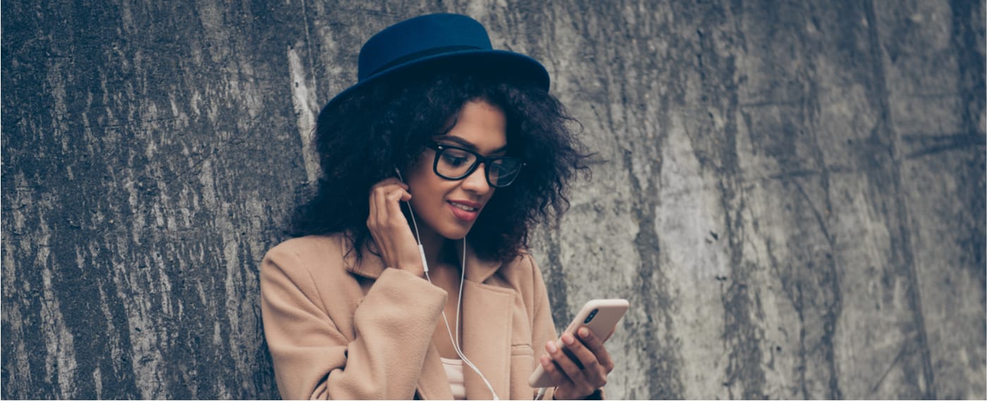Stylish girl using headphones to listen to self-talk app