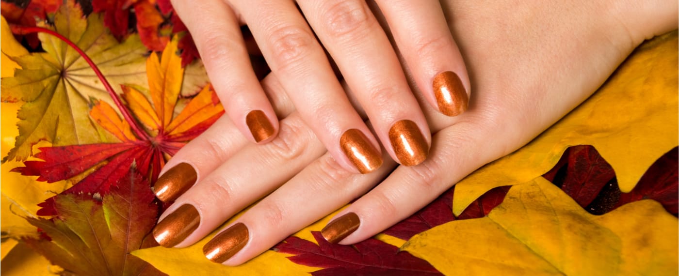 woman showing off trendy fall nail manicure