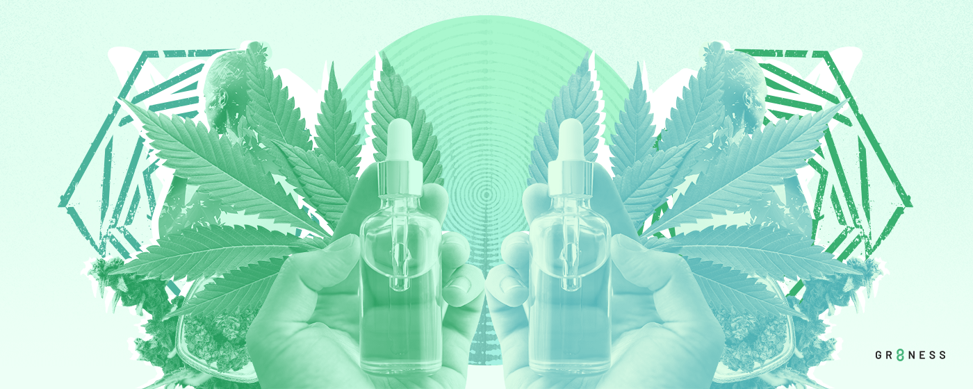 Bottles of CBD oil in front of hemp plants