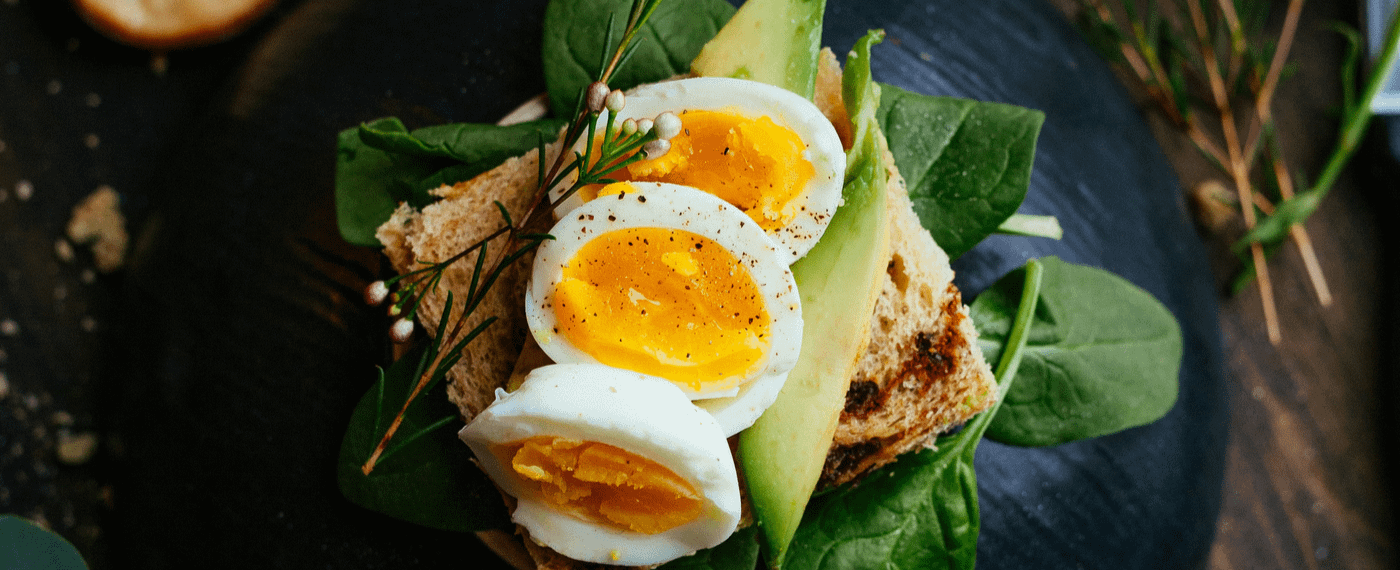 Boiled eggs over toast and spinach