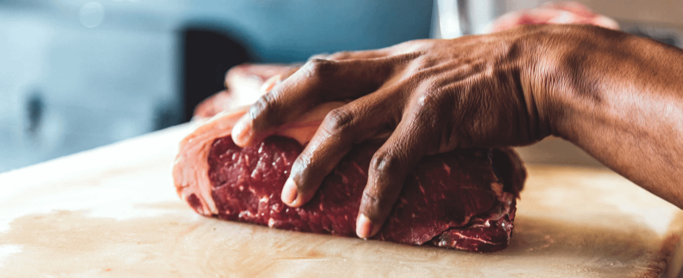 Man holding a piece of steak