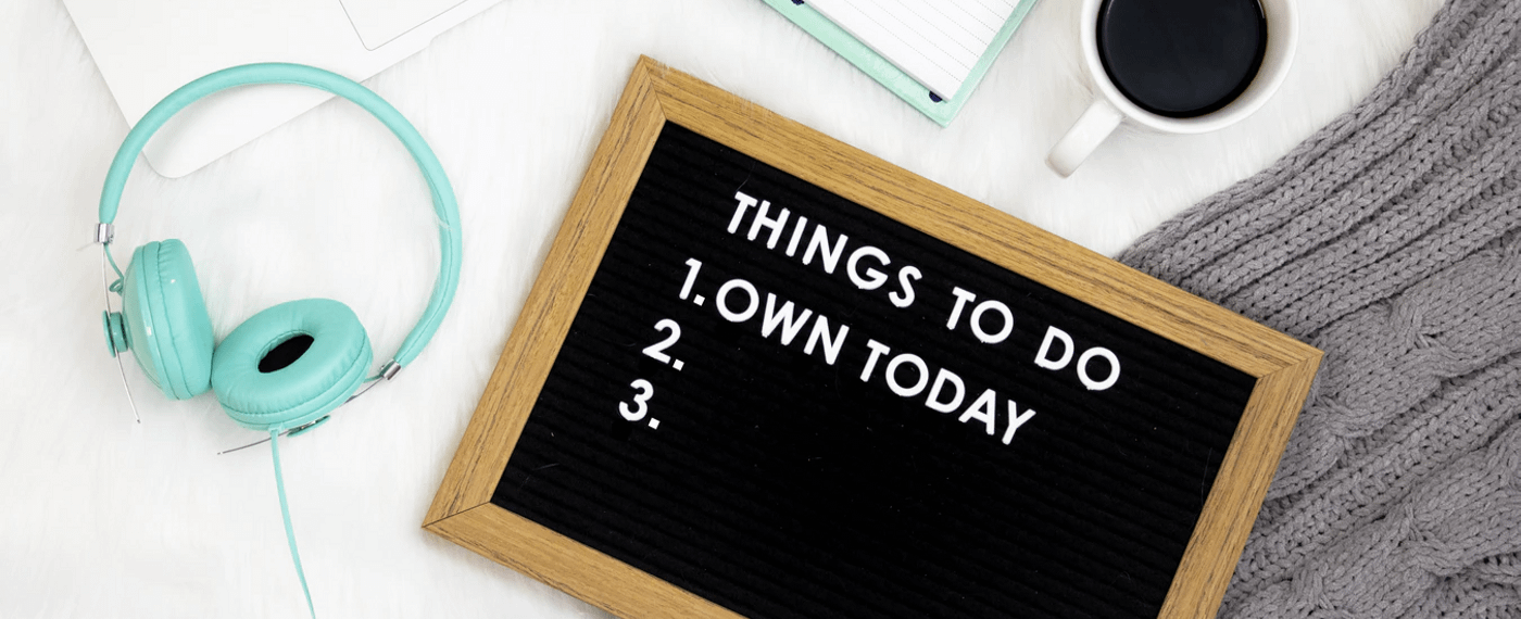 Mini cork board that says "own today" on table
