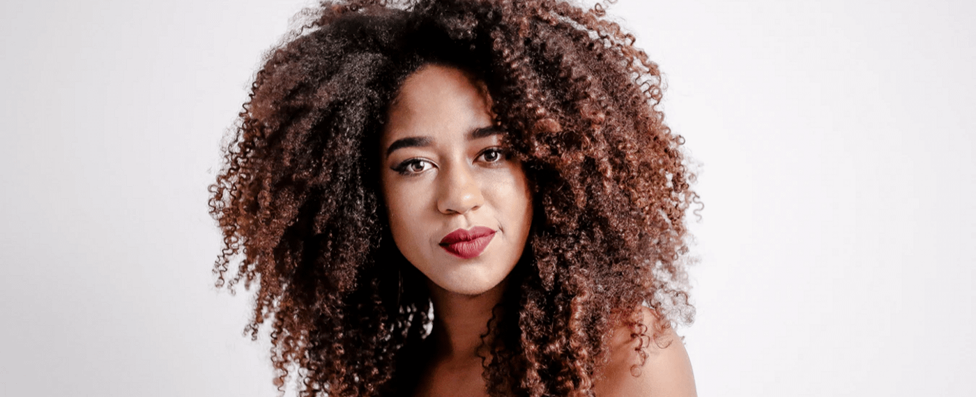 Woman with curly hair against white background
