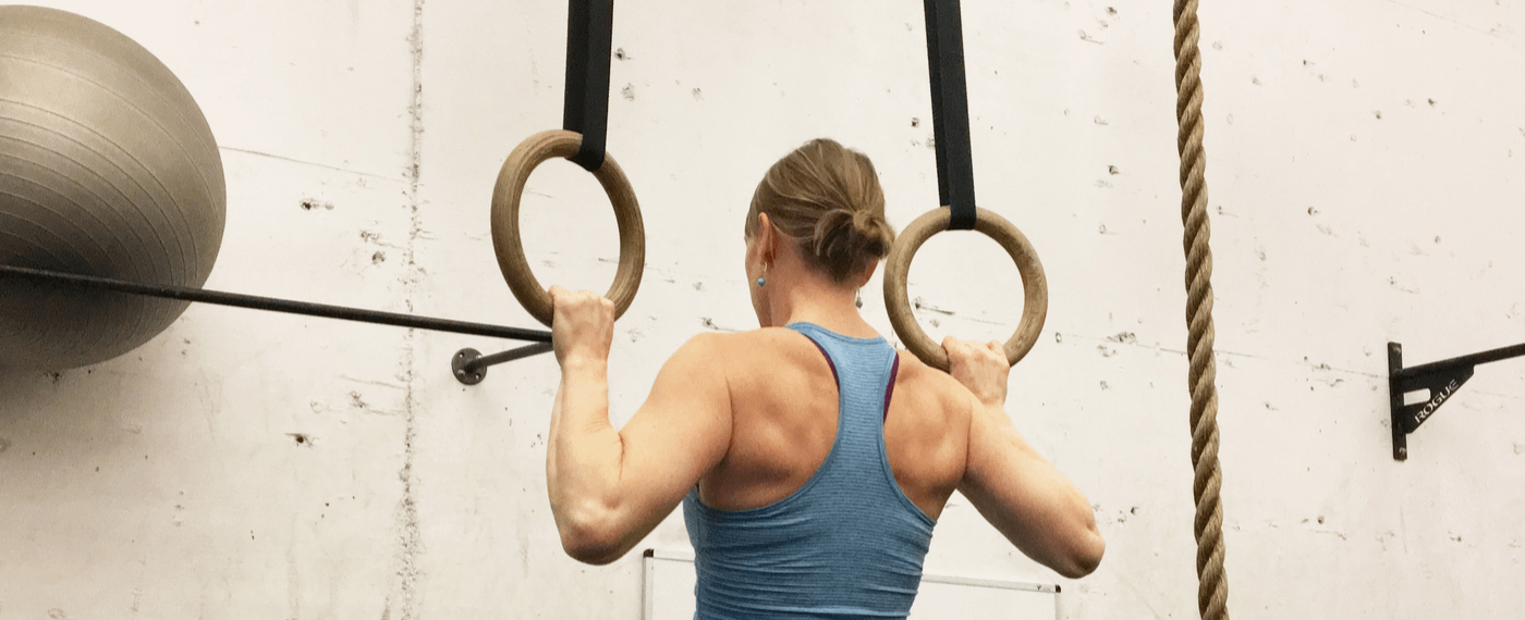 Woman working out with gymnastics rings