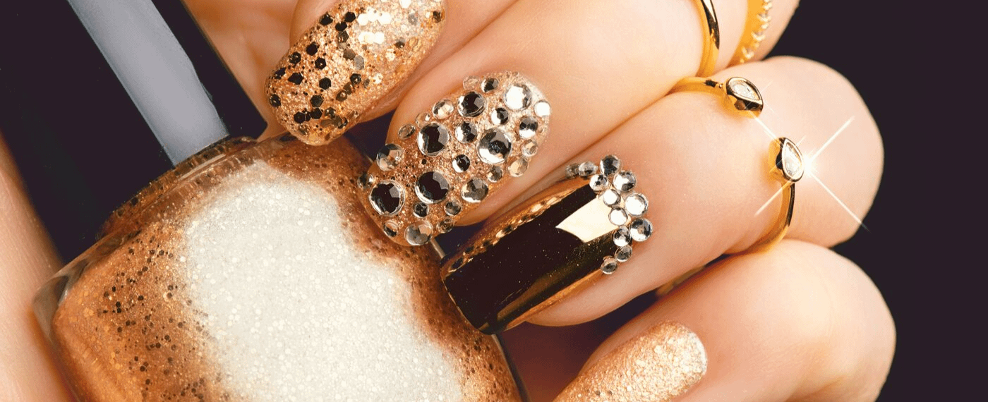 Close up of glamorous gold manicure and nail polish