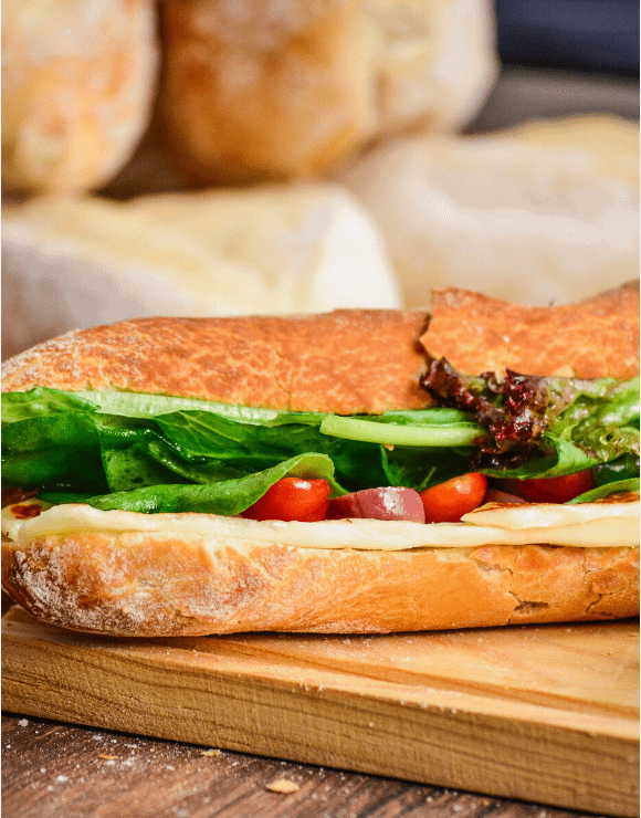 gluten-free pressed sub with cheese, lettuce, and tomatoes