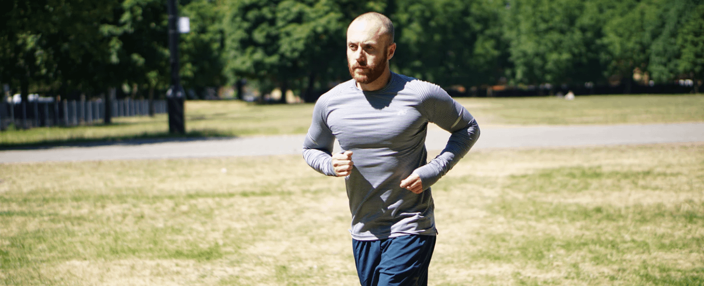 Athletic male running outdoors in the sun
