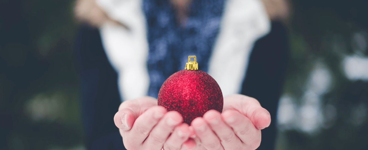 Woman holding a single holiday bulb in her hands