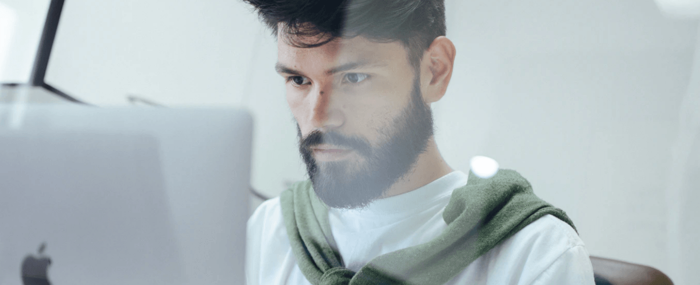 Man working intensely on laptop