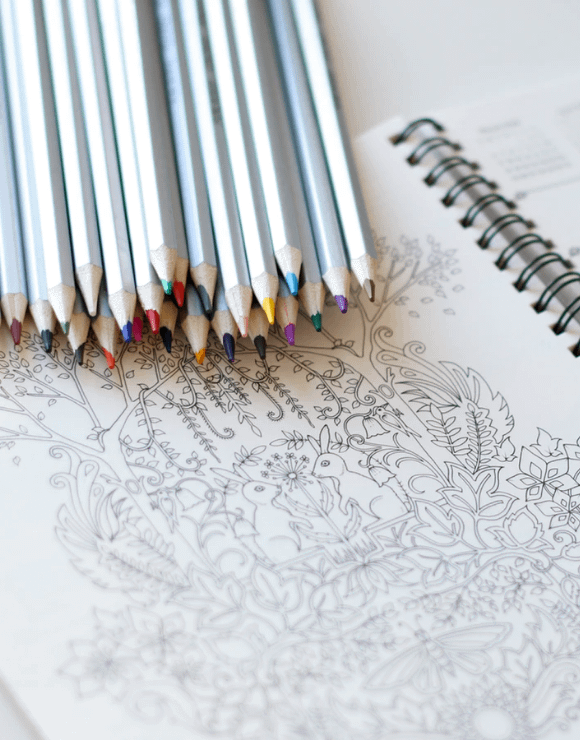 An assortment of colored pencils to color a detailed illustration