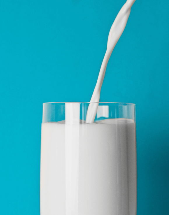 Milk being poured smoothly into a glass
