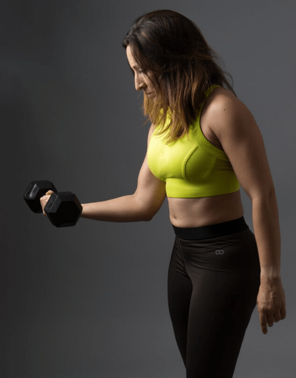 Fit female holding a dumbbell in one arms