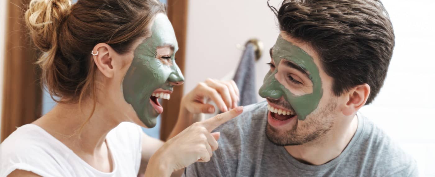 man and woman with skin care masks on
