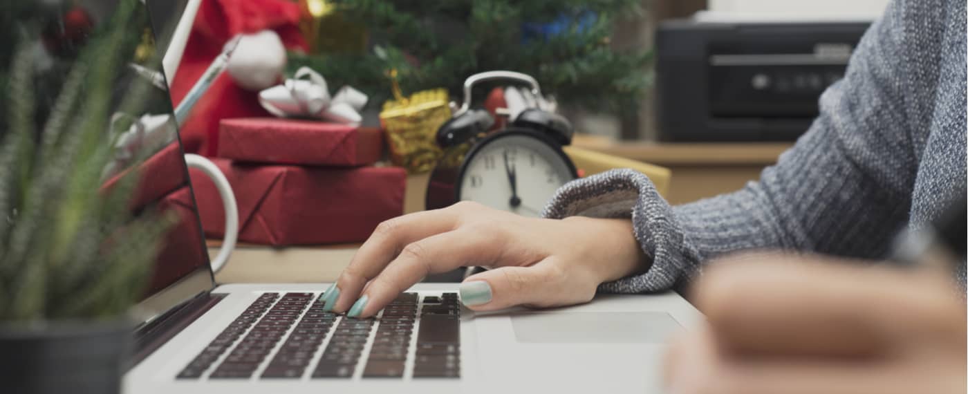 A woman scrolls through joyous holiday desktop wallpapers