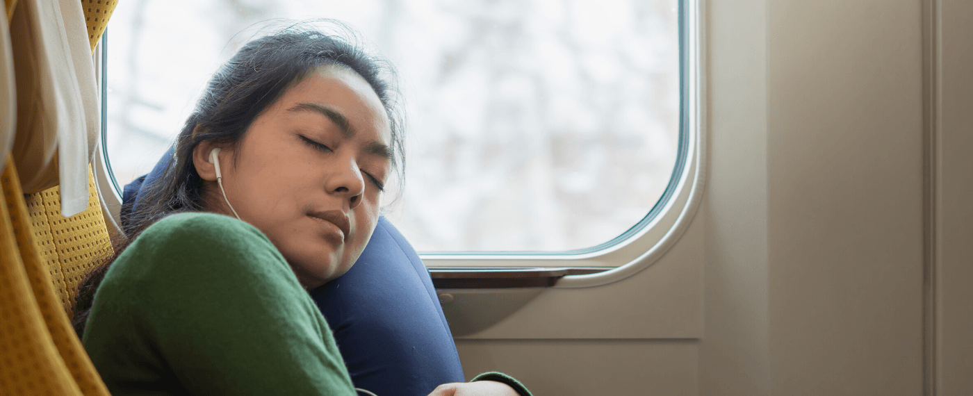 A woman sleeps during a long commute