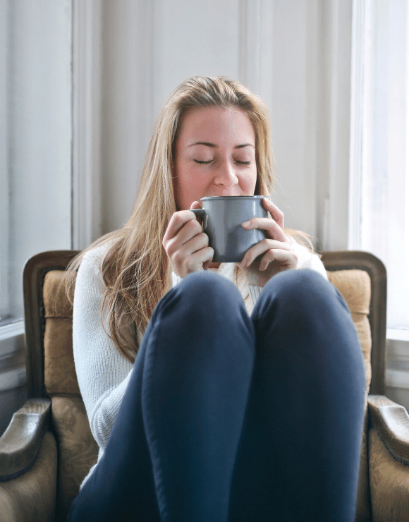 New mother unwinds from stressful day with hot cup of tea
