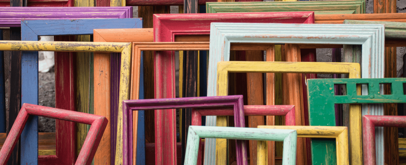 An eclectic collection of picture frames of all sizes and colors