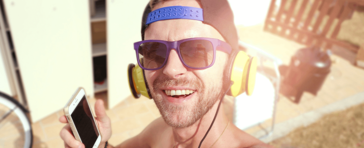 Man with sunglasses smiling listening to music
