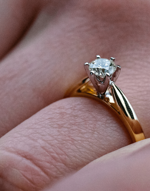 A single diamond wedding ring with a gold band