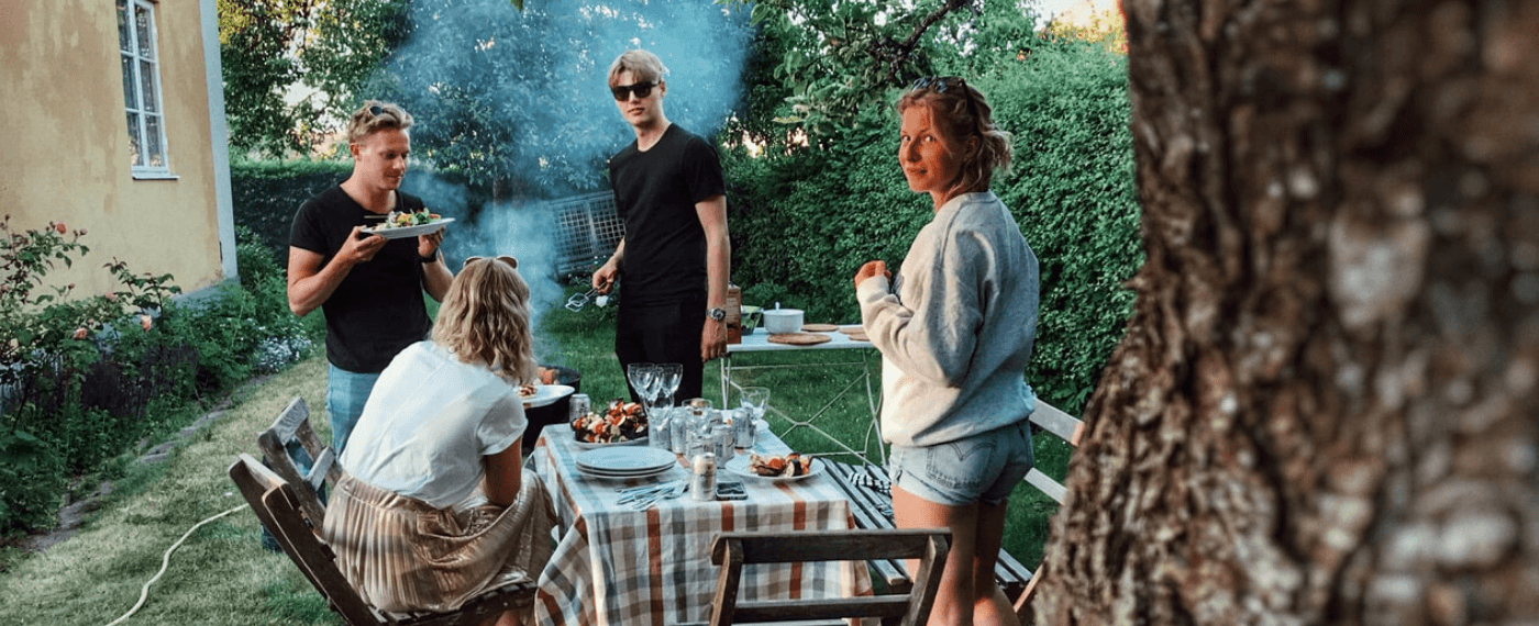 Family of four barbecuing healthy options from Trader Joe's for dinner outdoors