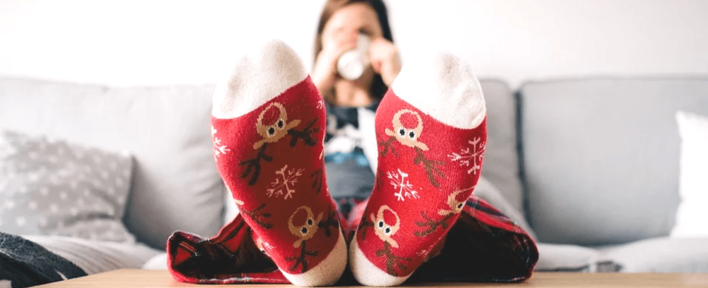 woman relaxing while wearing holiday socks