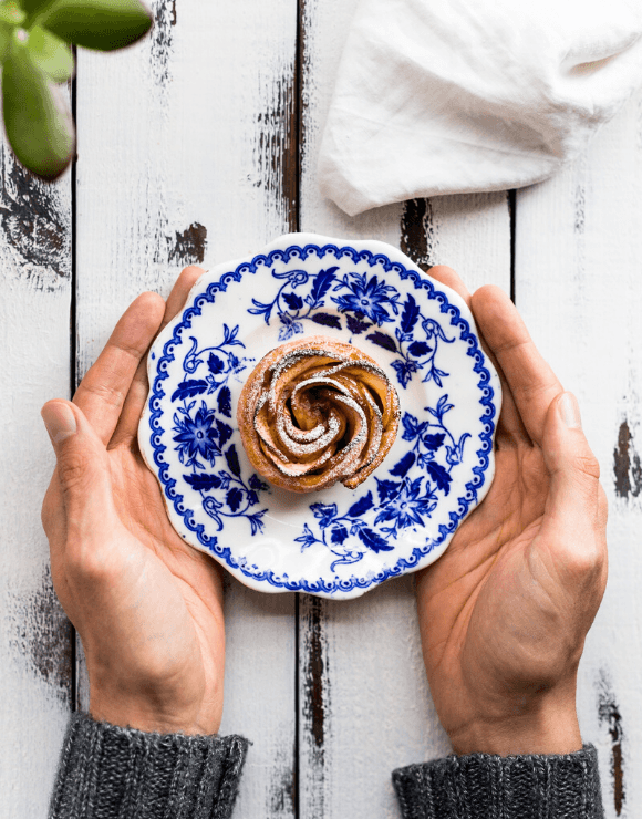 Spiral pastry on a dessert plate with powdered sugar on top