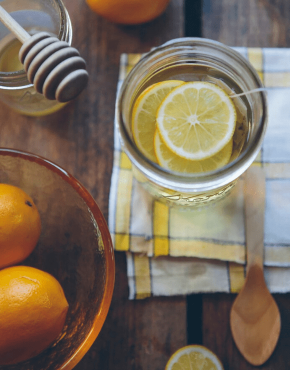 Jar of fresh cut lemons used for making warm lemon water to help with gut health