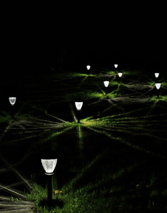Solar power lawn lights illuminating a field at night
