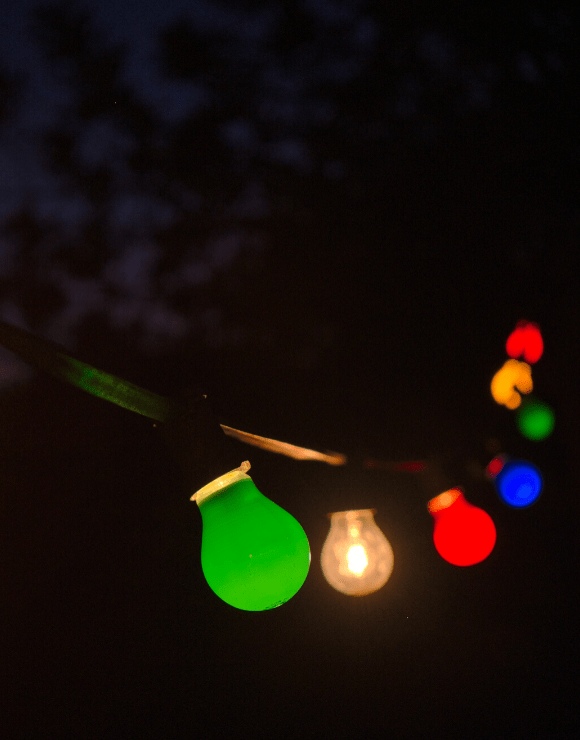 string of festive light bulbs hanging in a row