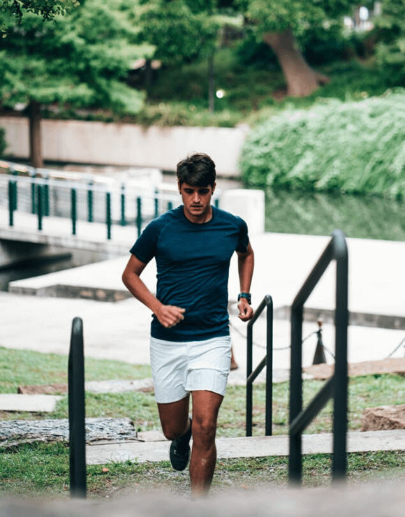 Fit male execrisinsg outdoors using stairs