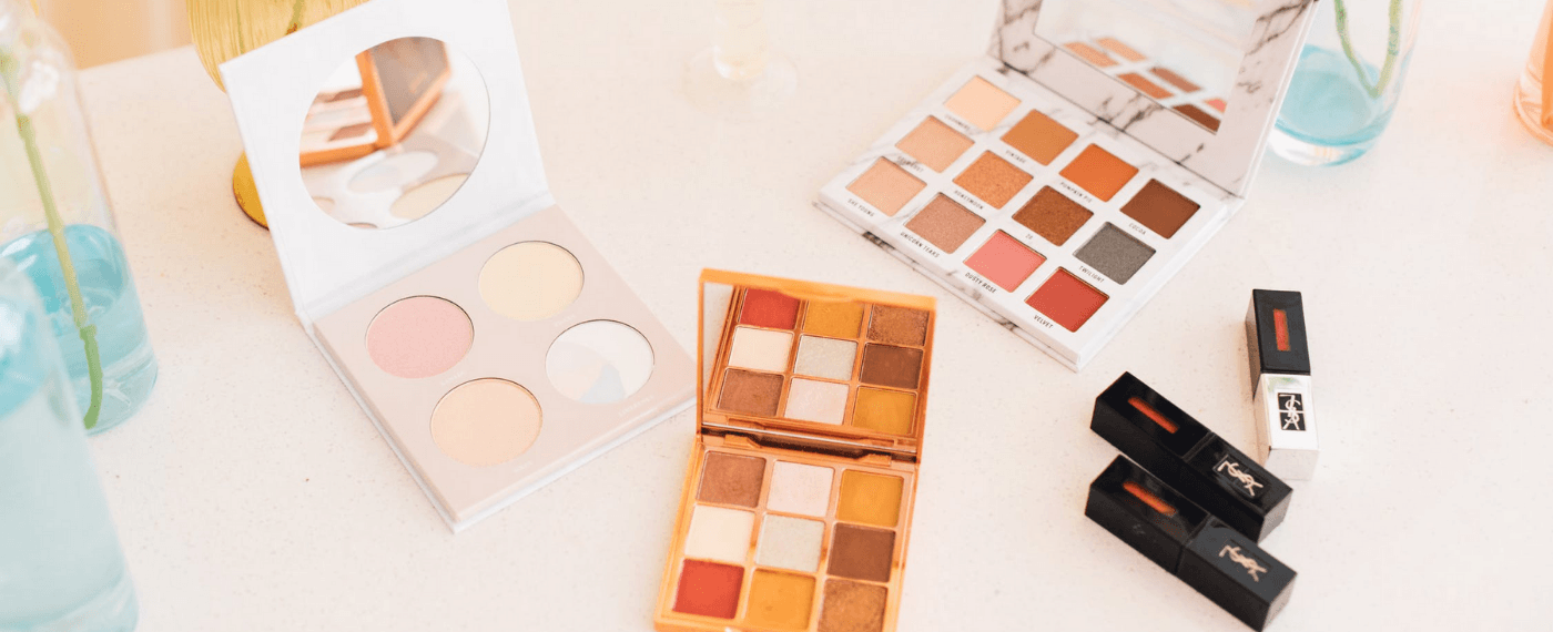 A variety of colorful makeup pallets and lipsticks
