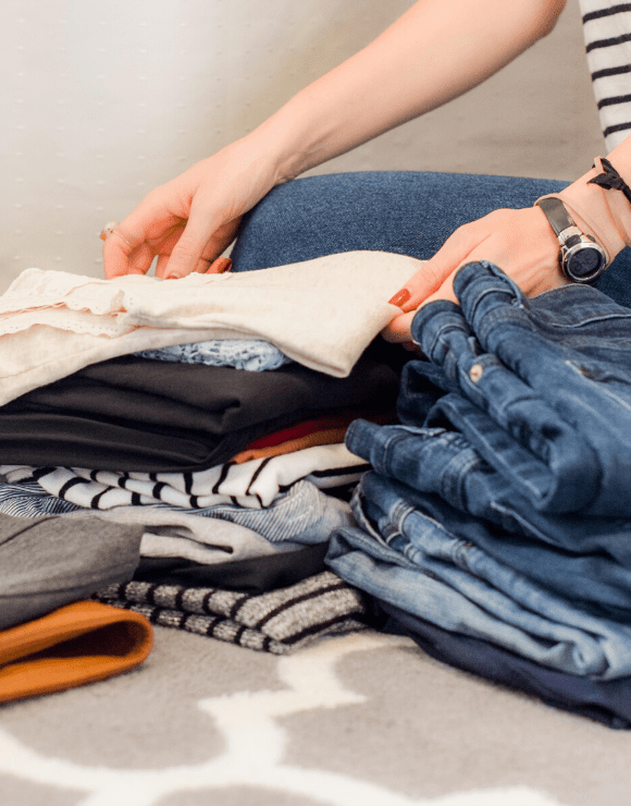 woman folding shirts on top of each other