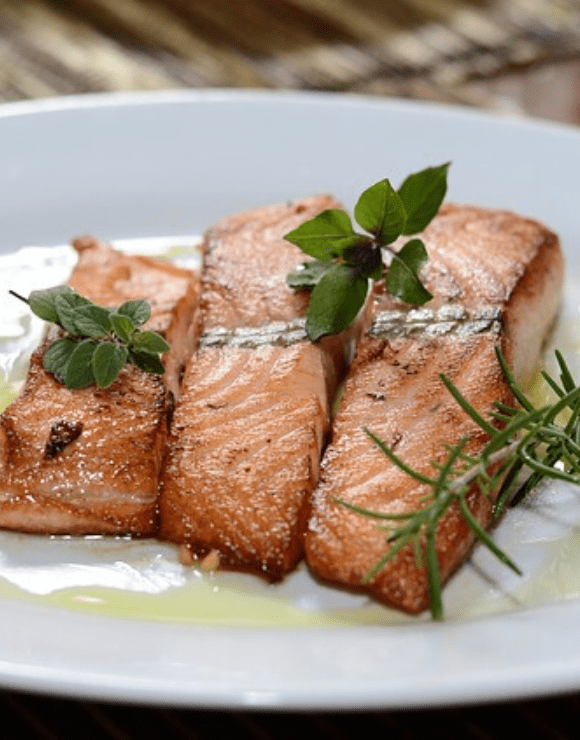 pieces of seared salmon on a plate that aid in respiratory health