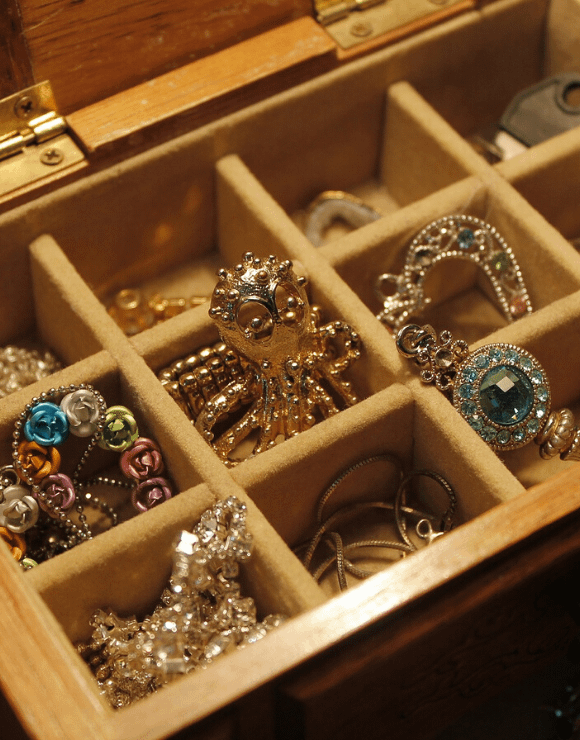 A jewelry box filled with rings and charms