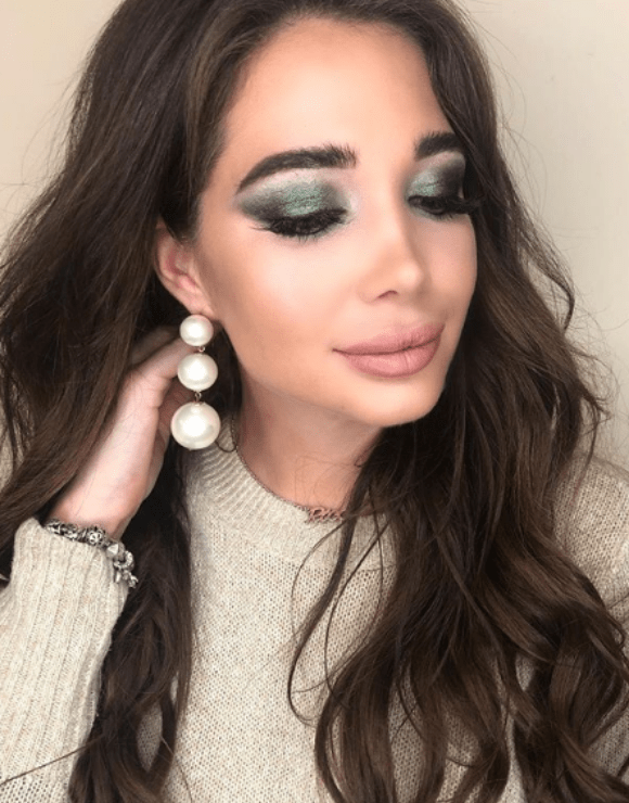 woman modeling green smokey eye makeup