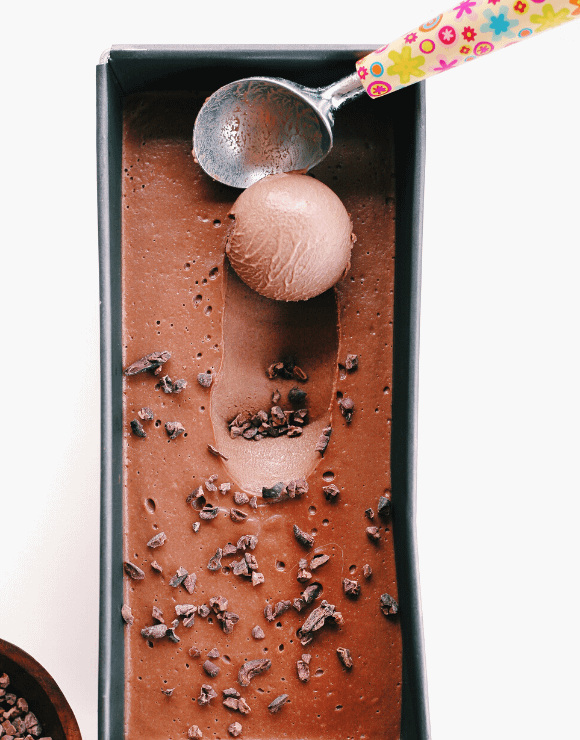 Hazelnut dark chocolate ice cream with a scoop taken out
