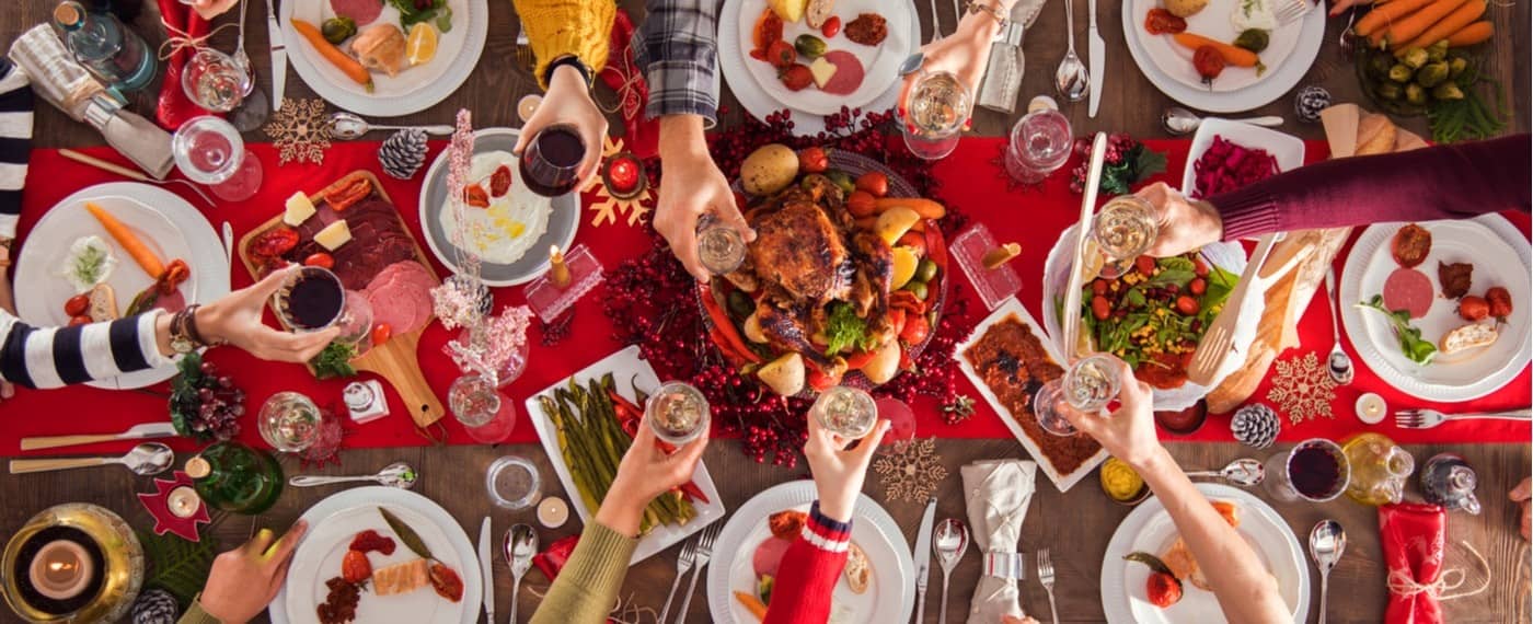 Large dinner table with a variety of holiday recipes