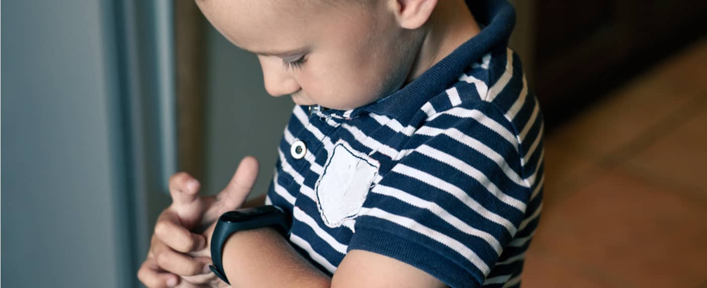 Young boy adjusting his Fitness Tracker Watch