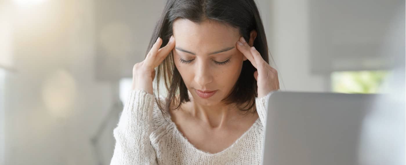 woman with her hands on her temple dealing with stress