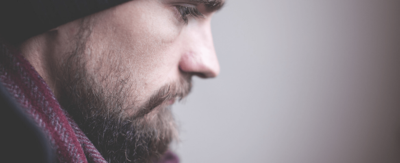 Bearded man thinking about seeking help for mental health aid