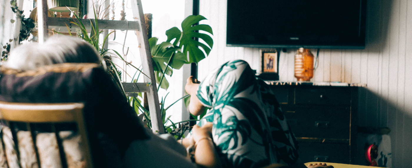 woman sitting in chair watching movies about mental health
