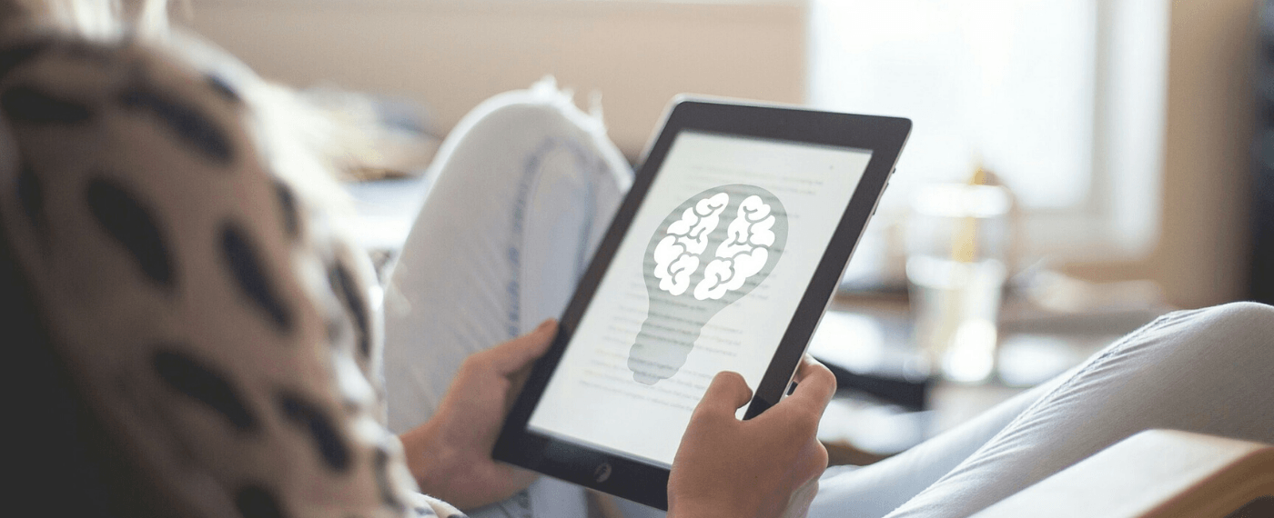 Woman reads an article about brain consciousness on her tablet