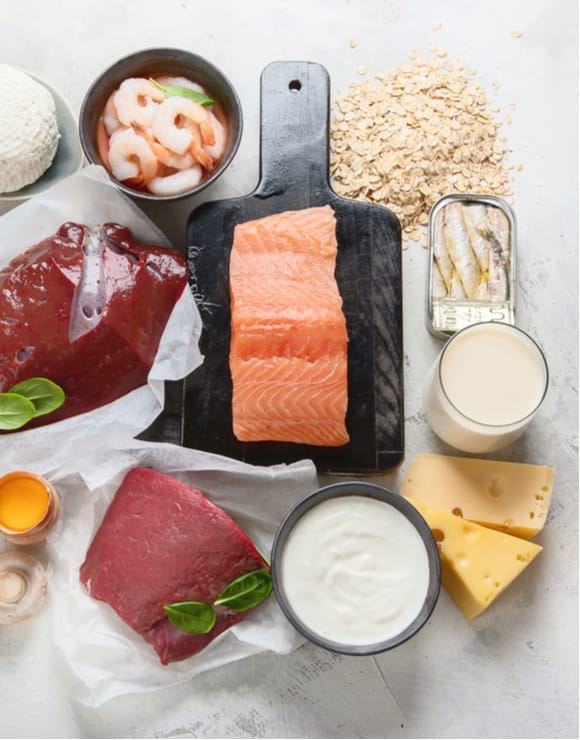 A variety of healthy foods rich in vitamin b12 such as salmon, cheese, and oats