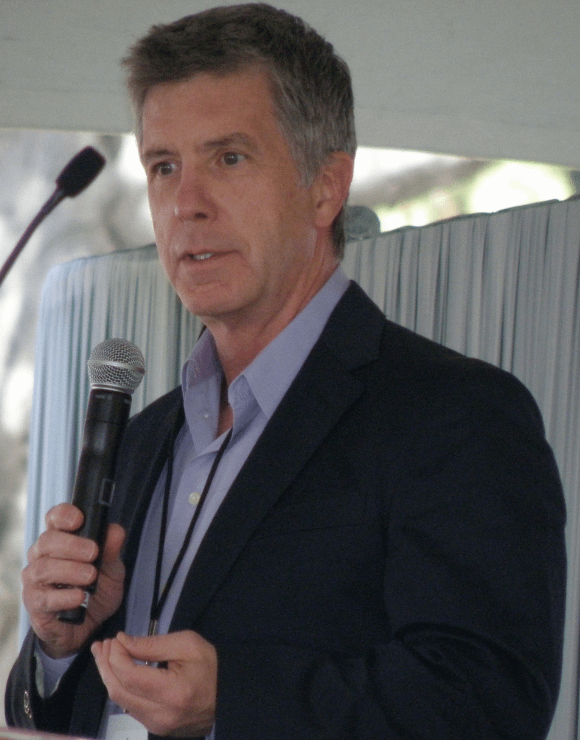 Tom Bergeron holding a microphone during a speech