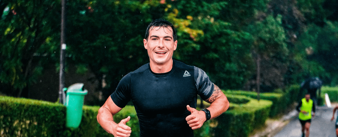 Athletic male running the rain to stay active for 2020