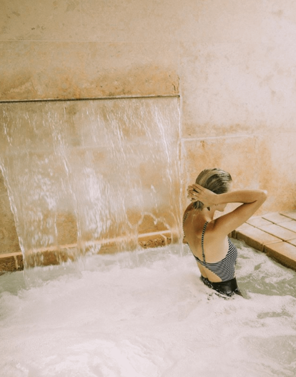 Woman relaxing in a luxury CBD spa tub